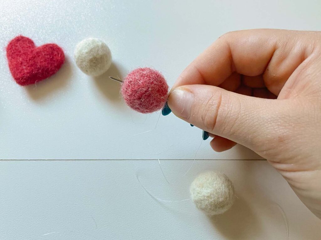 Felted balls with needle through it 