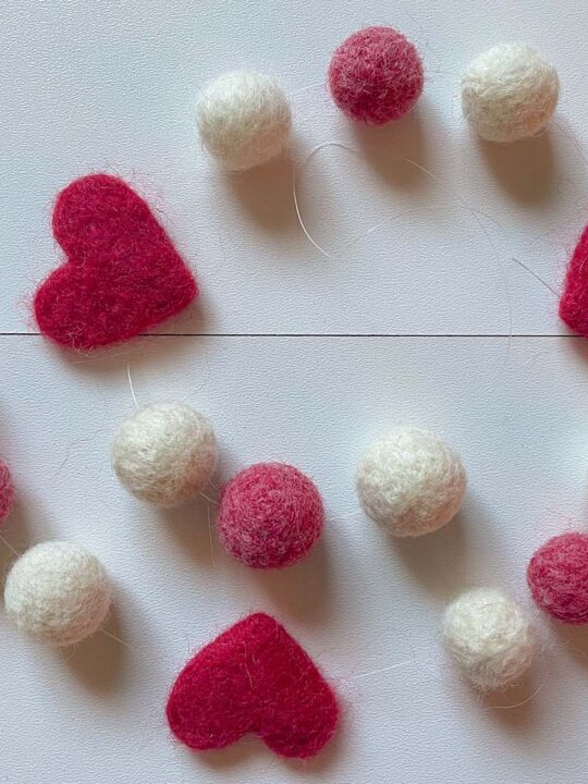 Red and white felted balls on a table